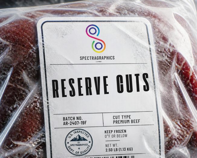 A SpectraGraphics Reserve Cuts label on a frost-covered package of frozen beef, marked Keep Frozen, 0°F or below